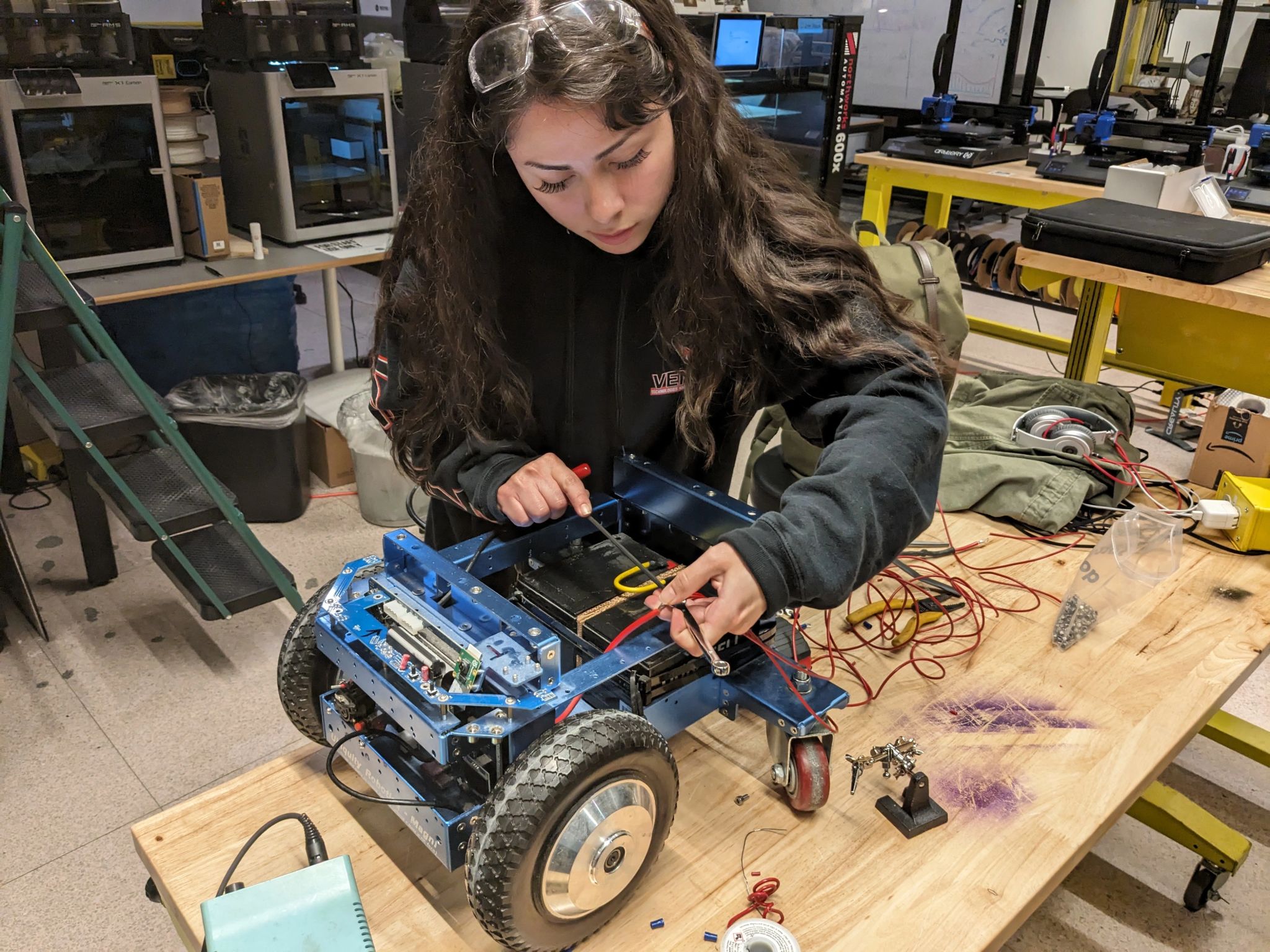 Giselle, HRG Lead, repairs Lil Spud Robot